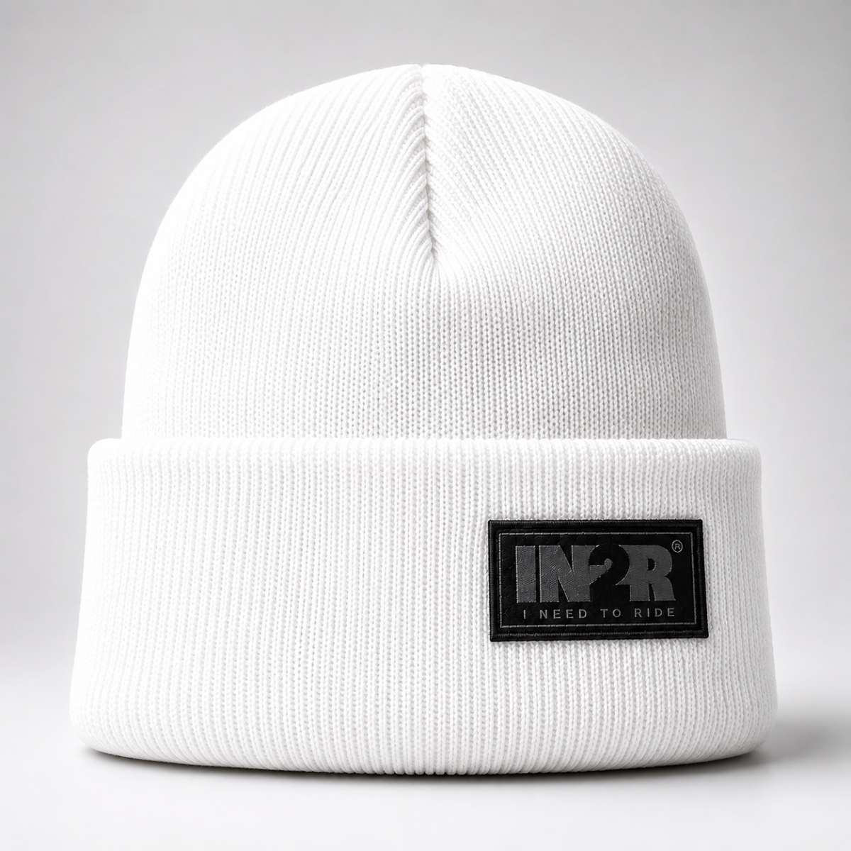 White IN2R Original Knit Beanie featuring a soft acrylic knit and signature woven logo patch.