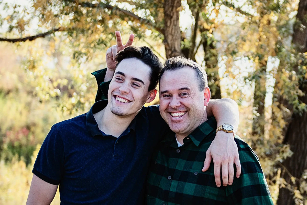 Scott Anderson and his son Aidan smiling together outdoors, featured in an IN2R Clothing story about a father’s perspective on supporting a child through mental health struggles.
