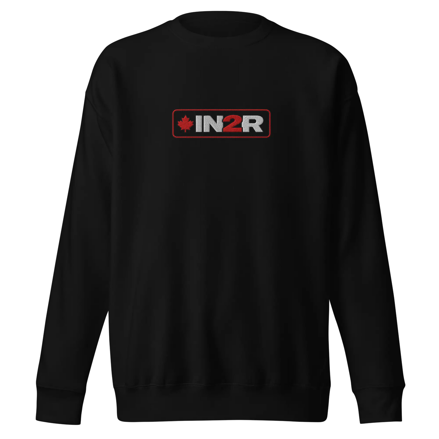 A black crewneck sweatshirt with a rectangular chest graphic that reads 'IN2R' in white and red, featuring a small red maple leaf on the left side, shown against a plain white background.