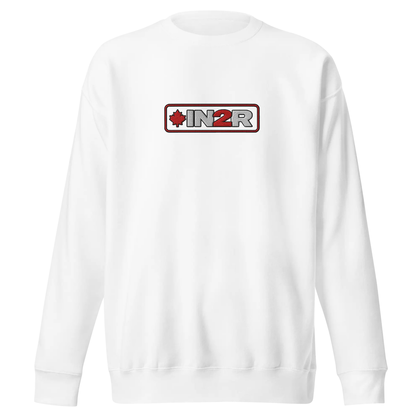 A white crewneck sweatshirt with a rectangular chest graphic that reads 'IN2R' in gray and red, featuring a small red maple leaf on the left side, set against a plain white background.