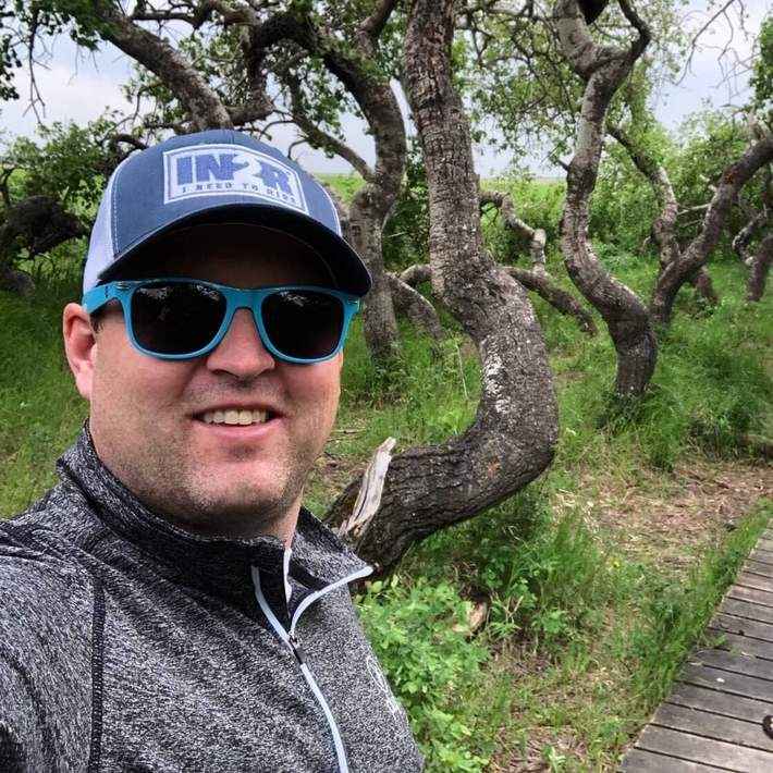 Chris May wearing an IN2R Original trucker hat outdoors
