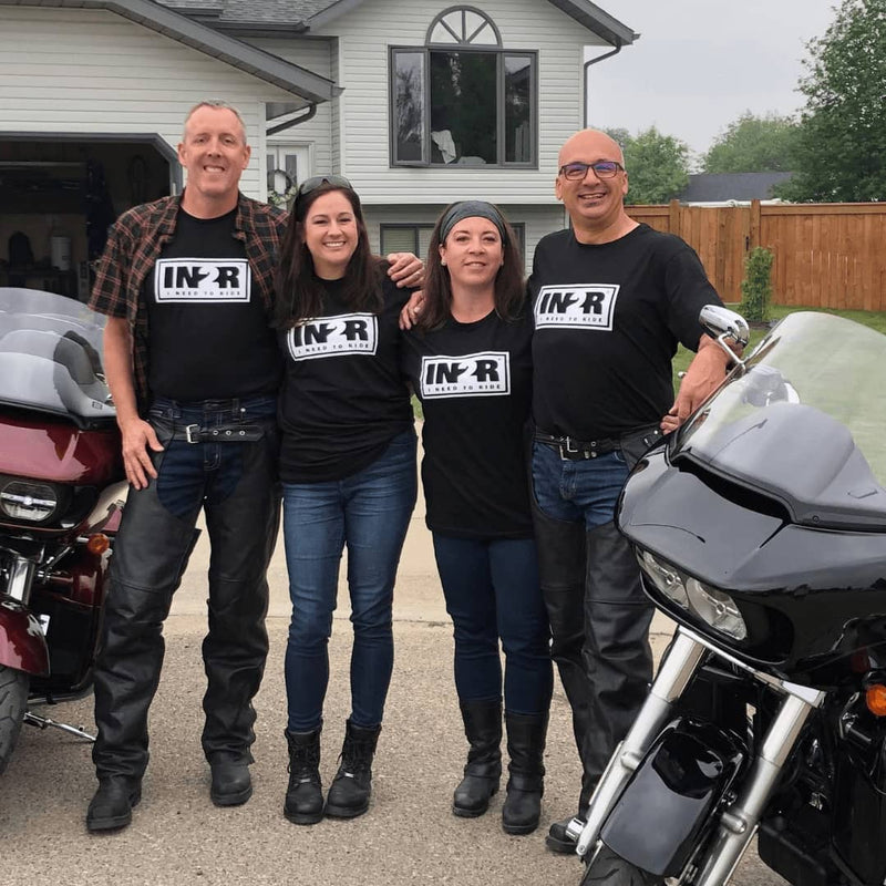 Four IN2R customers wearing black Original T-shirts beside motorcycles