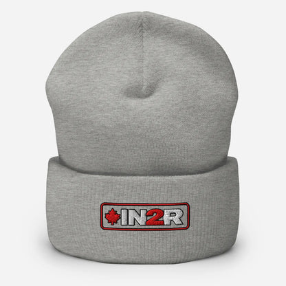 A light gray heather knit beanie with a folded cuff, featuring a rectangular embroidered patch on the front with the text 'IN2R' in white and a red maple leaf.