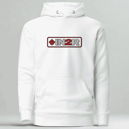 A white pullover hoodie with a front kangaroo pocket and a chest graphic that reads 'IN2R' with a red maple leaf icon, shown on a light gray background.