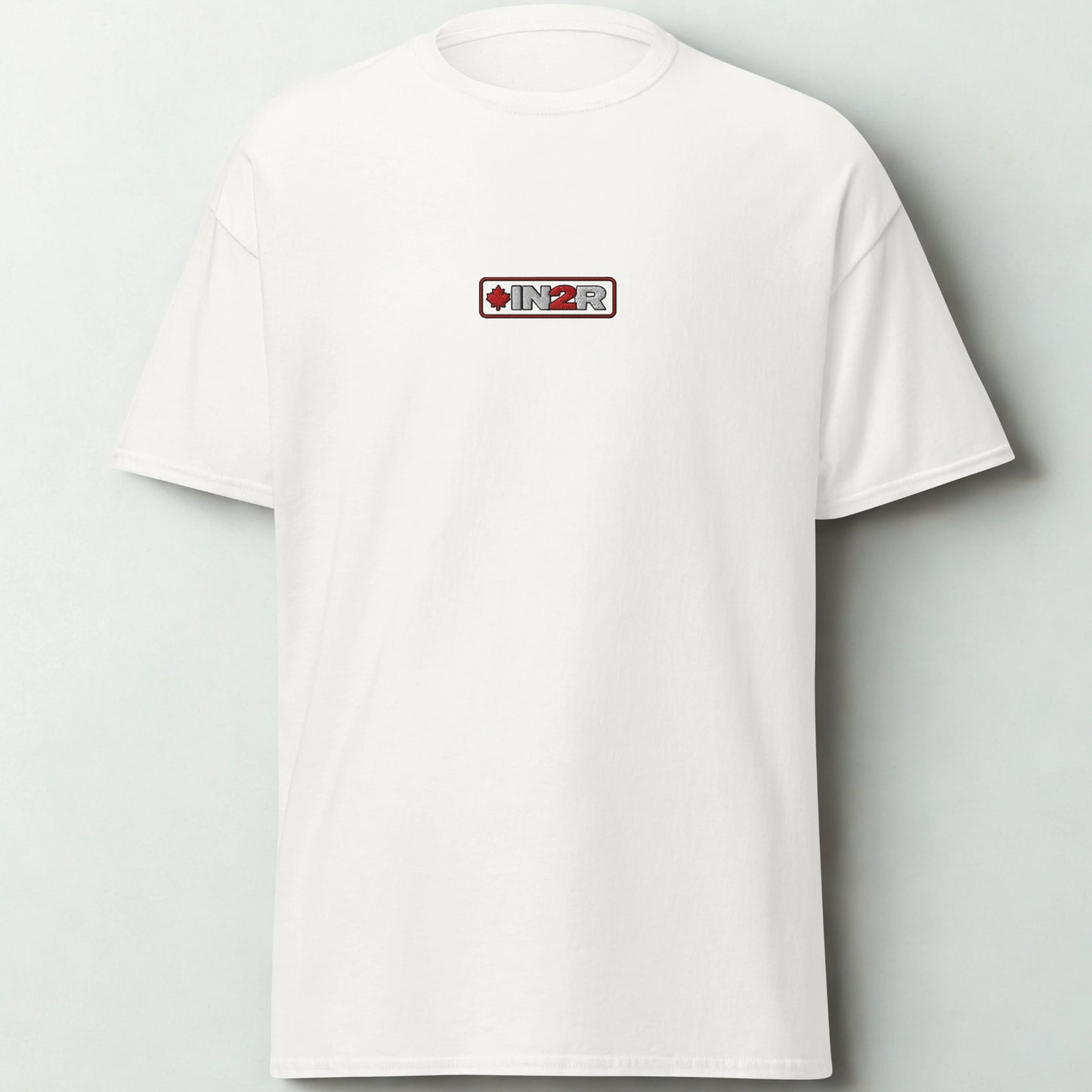 A white short-sleeve crewneck t-shirt with a small rectangular chest graphic featuring the brand name 'IN2R' and a red maple leaf, displayed against a light gray background.