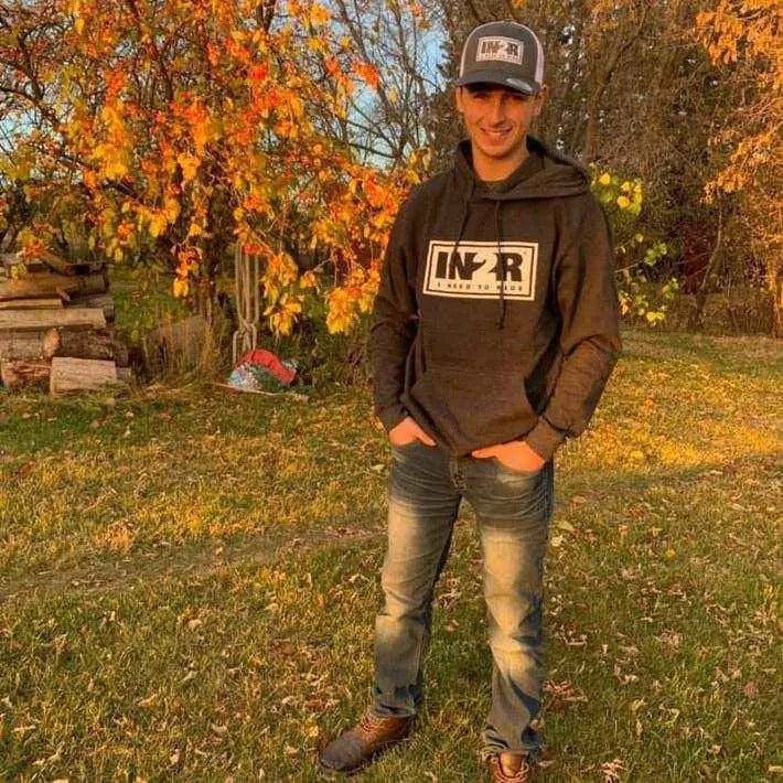 Declan Trudel wearing an IN2R Original hoodie and trucker hat outdoors