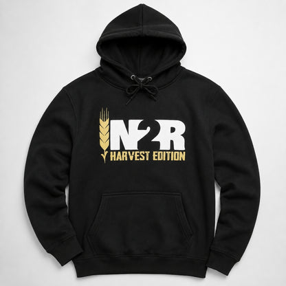A black pullover hoodie with a front kangaroo pocket and drawstring hood, featuring a large white and gold 'IN2R HARVEST EDITION' graphic on the chest, displayed against a light gray background.