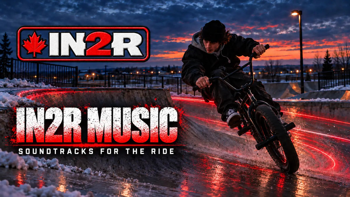 Promotional graphic for IN2R Music Soundtracks for the Ride, featuring a BMX rider leaning on a bike in a snowy outdoor skatepark at sunset. Large text reads 'IN2R MUSIC' and 'SOUNDTRACKS FOR THE RIDE' with the IN2R logo at top left.
