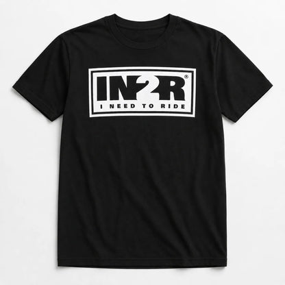 A black short-sleeve crewneck t-shirt featuring a bold white graphic on the chest with the letters 'IN2R' and the text 'I NEED TO RIDE' underneath, displayed against a clean white background.