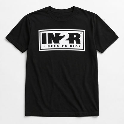A black short-sleeve crewneck t-shirt with a white rectangular graphic on the chest featuring the stylized letters 'IN2R' and the text 'I NEED TO RIDE'.