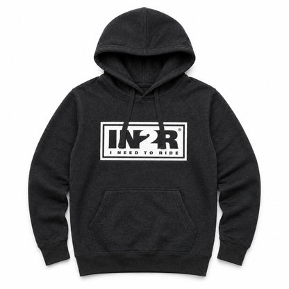 A dark charcoal gray heather pullover hoodie with a white rectangular chest graphic that reads 'IN2R I NEED TO RIDE'. The hoodie features a front kangaroo pocket and drawstring hood, shown against a plain white background.