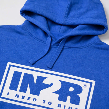 A close-up of a royal blue hoodie featuring a white graphic box on the chest with the text 'IN2R' and 'I NEED TO RIDE' in blue.