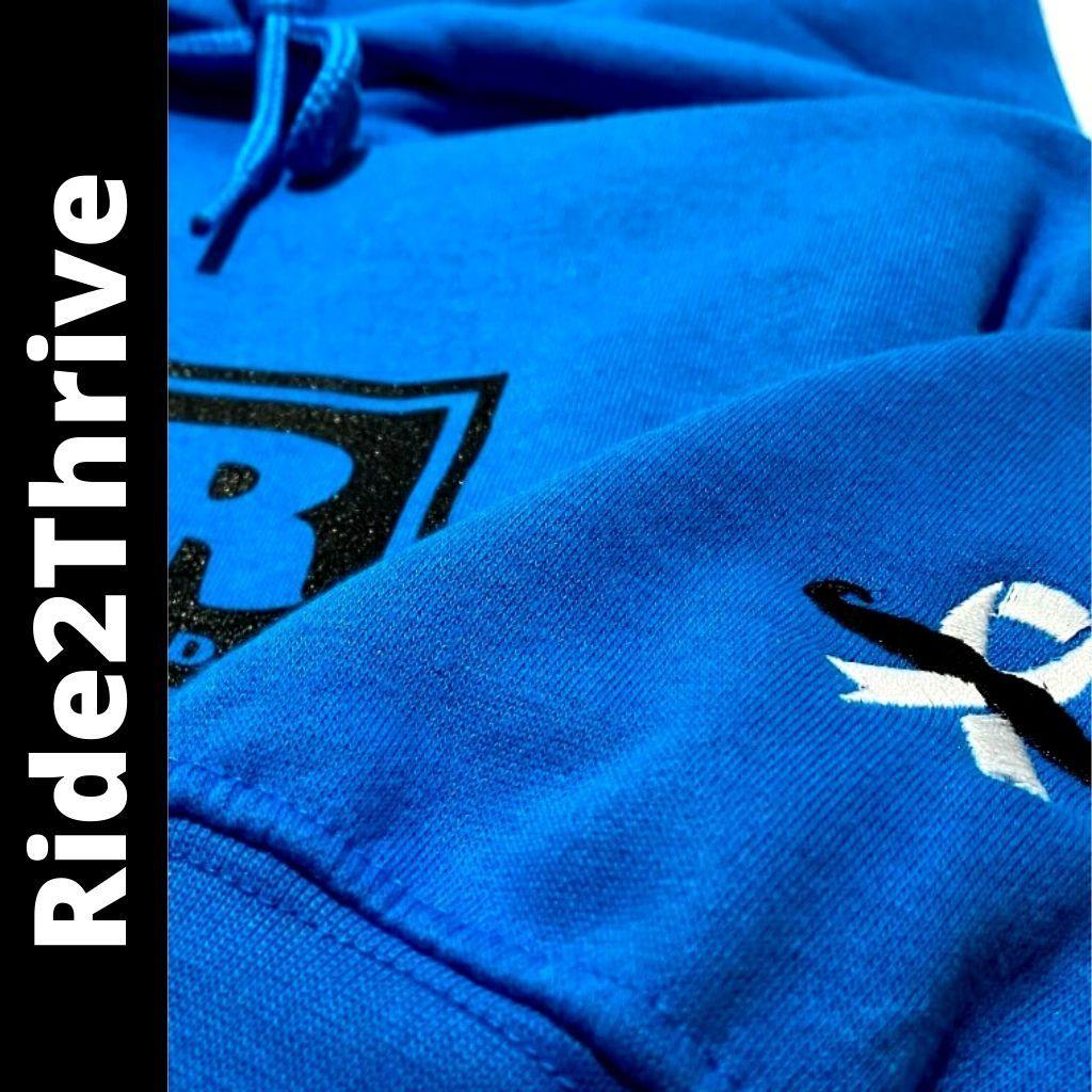 Sapphire blue IN2R Ride2Thrive unisex hoodie with embroidered men’s health ribbon on the sleeve